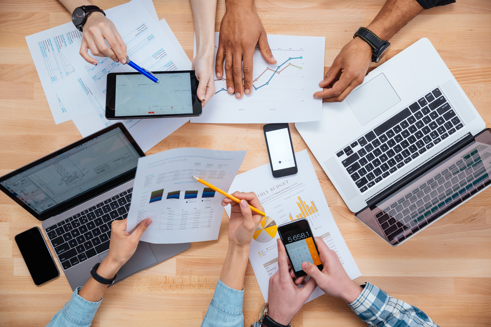 Business people using mobile phones and laptops, calculating and discussing charts and diagrams for financial report-1